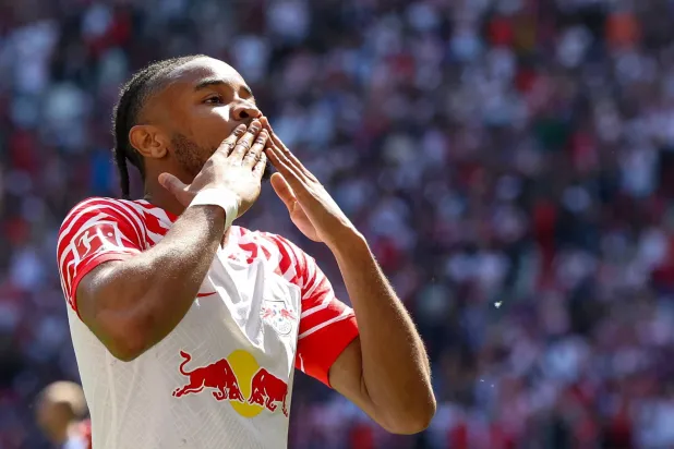 Leipzig's French forward Christopher Nkunku (R) celebrates scoring 2-0 during the German first division Bundesliga football match between RB Leipzig and FC Schalke 04 in Leipzig, eastern Germany on May 27, 2023. (AFP) 