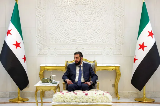 Syria's interim president Ahmad al-Sharaa attends a meeting with his foreign minister and the leader of the Kurdish-led Syrian Democratic Forces (SDF), at the People's Palace in Damascus on August 25, 2026. (AFP)