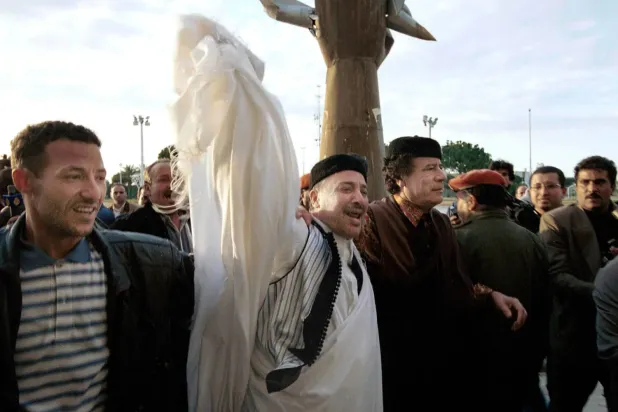 Libya’nın merhum lideri Muammer Kaddafi ile beraatının ardından başkent Trablus’a dönüş yapan Emin Halife Fahime’yi (soldan ikinci) bir arada gösteren fotoğraf. Fahime, uçak bombalama davasından kesin olarak beraat etmesinin ertesi günü Trablus’a ulaşmıştı (1 Şubat 2001) (Getty)