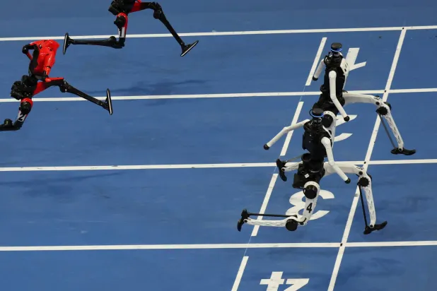  Tiangong Ultra humanoid robots cross the finish line before Honor's Lightning humanoid robots in the 100m large-size group final race, during the second World Humanoid Robot Games at the National Speed Skating Oval in Beijing, China August 26, 2026. (Reuters)