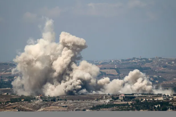 A photograph taken from the southern Lebanese area of Marjayoun shows smoke as it rises from the site of an Israeli controlled explosion in the village of Kfartibnit on August 24, 2026. (Photo by AFP) / 