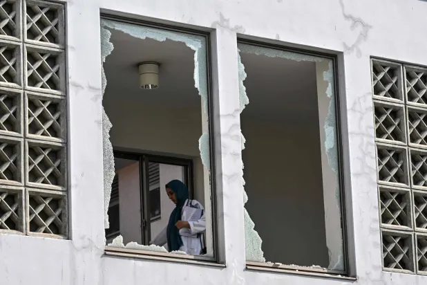 A medical staff member walks past a damaged corridor at the site, a day after a fire at the Mother and Child Health ward of the Pakistan Institute of Medical Sciences (PIMS) Hospital in Islamabad on August 27, 2026. (AFP)