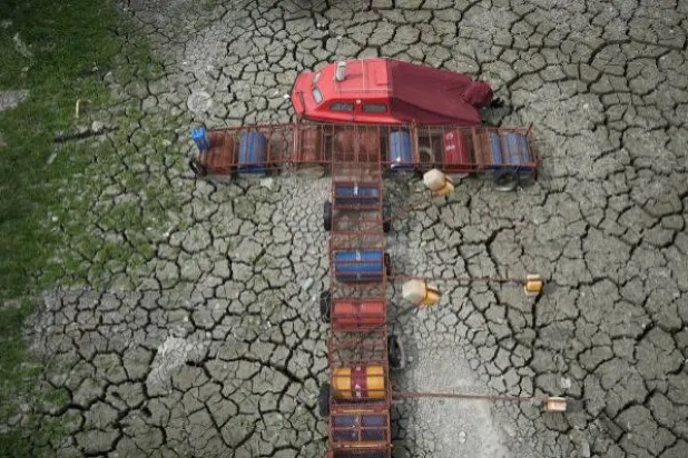A boat sits on dry ground as water levels have dropped on the Danube in Petrovaradin, Serbia, Tuesday, August 25, 2026. (AP Photo/ Darko Vojinovic)