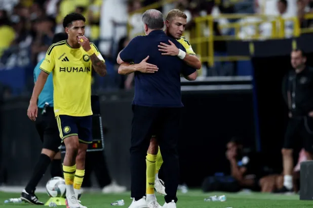 مدرب النصر يحتضن رونالدو لحظة تغييره في مباراة التعاون (رويترز)