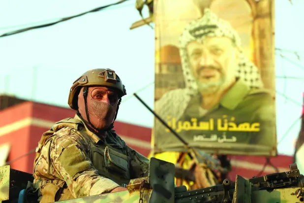 A Lebanese soldier sits on an armored personnel carrier at the entrance of Burj Barajneh Palestinian refugee camp in southern Beirut, Lebanon, 21 August 2025.   EPA/WAEL HAMZEH