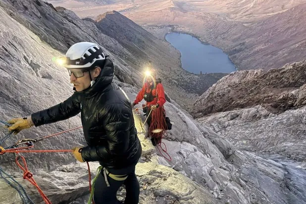 This photo released by the Mono County Search and Rescue shows volunteers conducting an operation to rescue a man stranded on a ledge in the Sierra Nevada, Calif., on Aug. 22, 2026. (Mono County Sheriff Search and Rescue via AP) 