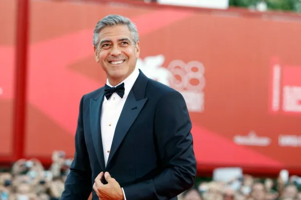 George Clooney poses on the red carpet at the premiere of his film "The Ides of March," opening the 68th edition of the Venice Film Festival in Venice, Italy on Aug. 31, 2011. (AP)