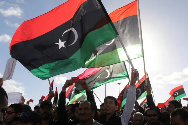 People wave Libyan flags during a demonstration in Benghazi February 7, 2014. (Reuters) 