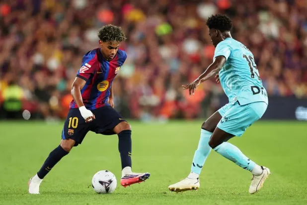 Football - LaLiga - FC Barcelona v Athletic Club - Spotify Camp Nou, Barcelona, Spain - August 27, 2026 FC Barcelona's Lamine Yamal in action with Athletic Club's Adama Boiro. (Reuters) 