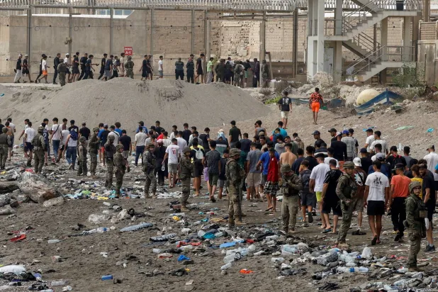 مواطنون يسيرون باتجاه الحدود مع المغرب مغادرين إسبانيا وسط عمليات عبور جماعية للمهاجرين سيراً على الأقدام وبحراً من المغرب إلى الأراضي الإسبانية في سبتة 31 يوليو 2026 (رويترز)