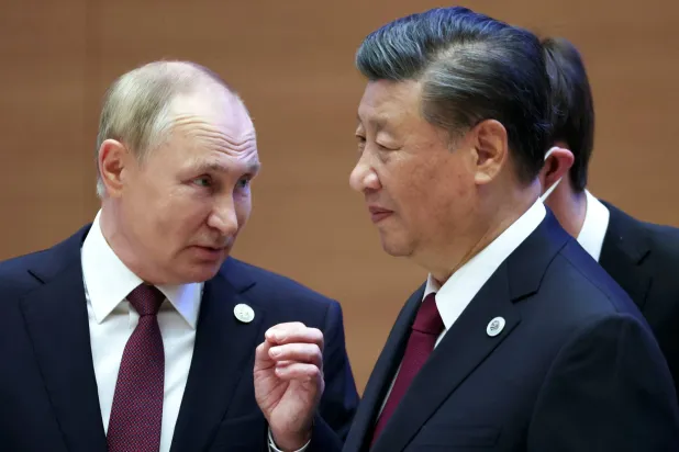 FILE - Russian President Vladimir Putin, left, gestures while speaking to Chinese President Xi Jinping during the Shanghai Cooperation Organization (SCO) summit in Samarkand, Uzbekistan, Sept. 16, 2022. (Sergei Bobylev, Sputnik, Kremlin Pool Photo via AP, File)
