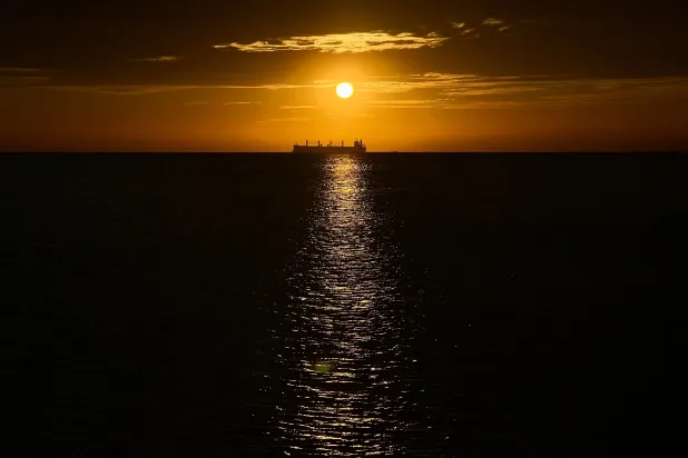An oil vessel is visible in the Caribbean Sea at sunset during a nearby conference aimed at transitioning away from fossil fuels April 28, 2026, in Santa Marta, Colombia. (AP)
