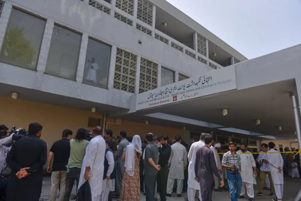 People gather outside a nursery in the gynecology ward following a fire at a hospital in Islamabad, Pakistan, Wednesday, Aug. 26, 2026. (AP)