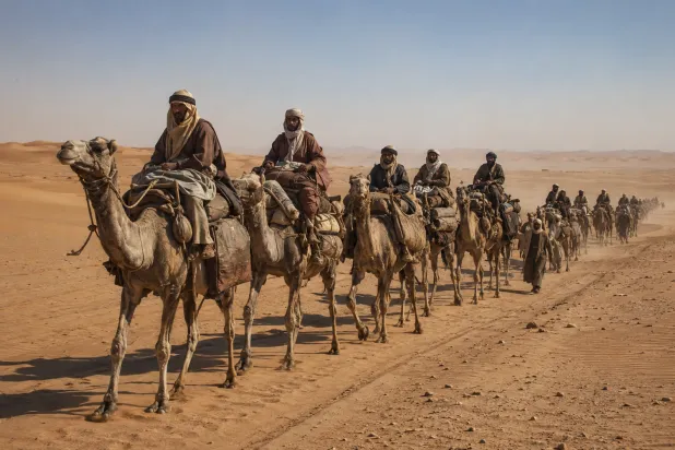 واجه رجال العقيلات وحشة الصحراء وخطر الموت بالتجارة والترحال (صورة مولدة بالذكاء الاصطناعي)