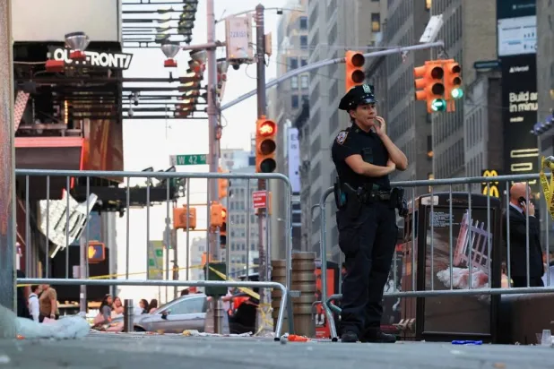 A member of the NYPD stands guard at the scene of an officer-involved shooting, in Times Square, New York City, US, August 31, 2026. (Reuters)