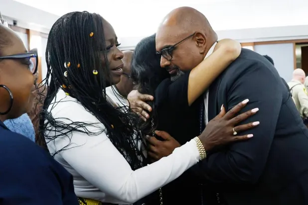  Friends and family members of rapper Tupac Shakur, including his sister Sekyiwa Shakur, second left, line up to hug Chief Deputy District Attorney Binu Palal, right, after a jury found Duane Davis guilty of first-degree murder in his trial related to the 1996 killing of rapper Tupac Shakur, at Clark County District Court Regional Justice Center, Monday, Aug. 31, 2026, in Las Vegas. (Bizuayehu Tesfaye/Las Vegas Review-Journal via AP, Pool) 