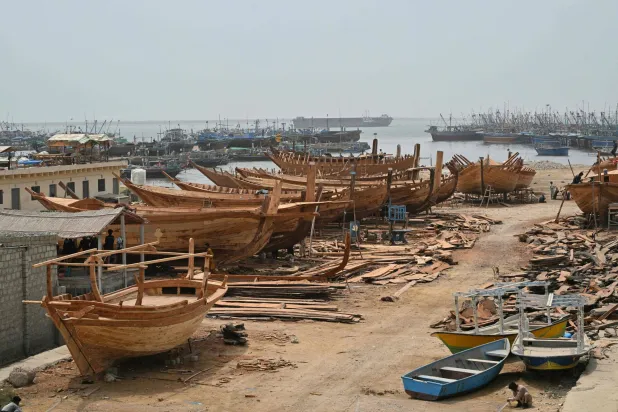 This photograph taken on July 8, 2026 shows traditional wooden boats at a yard in Ibrahim Hyderi in Karachi. (AFP)