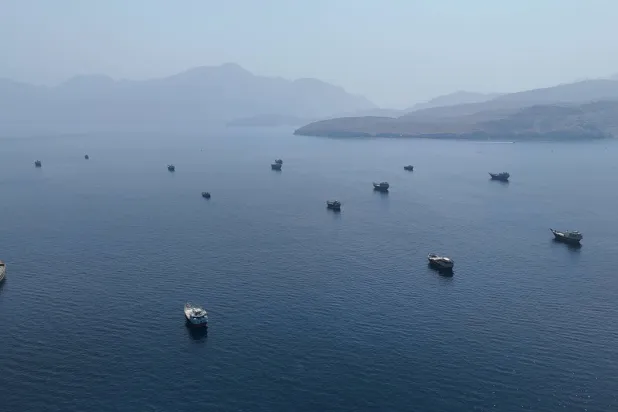 A drone view shows vessels near the Strait of Hormuz, as seen from Musandam, Oman, August 28, 2026. (Reuters)