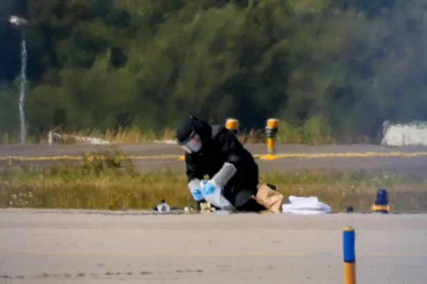 A police officer in protective clothing works at Leipzig/Halle Airport in Schkeuditz, Germany, August 5, 2026, after the police said explosives experts examined a drone near a runway. (Reuters) 