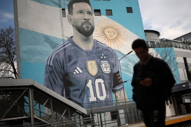 A commuter walks past a mural of Argentine soccer legend Lionel Messi, on the day he announced his retirement from the national team, at the Villa del Parque train station, in Buenos Aires, Argentina, August 31, 2026. (Reuters)