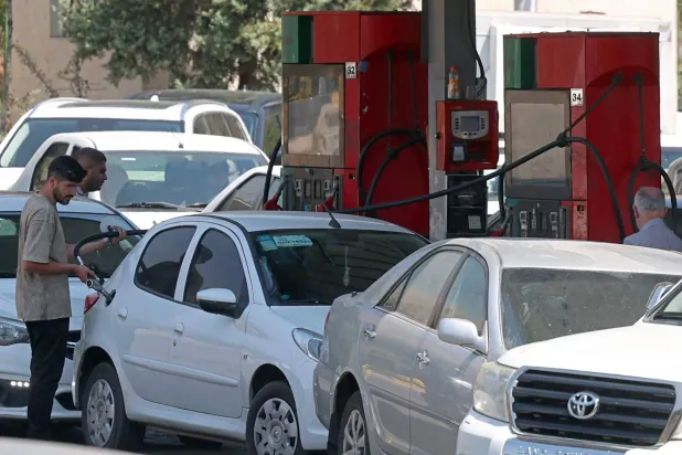 Drivers queue at a petrol station to refuel in Tehran, on August 25, 2026. (AFP)
