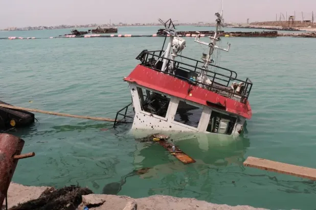  The navigation bridge of a sunken vessel is all that is seen at the surface of the water in the Port of Mokha the day after an attack by the Houthis on the city Mokha, held by Yemen's legitimate government on August 10, 2026. (AFP) 