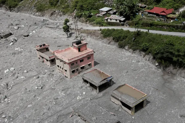 An aerial view shows houses standing amid debris during a helicopter flight from Nuwakot to Rasuwa following the deadly flash floods and mudslides in Nepal, September 3, 2026. (Reuters)