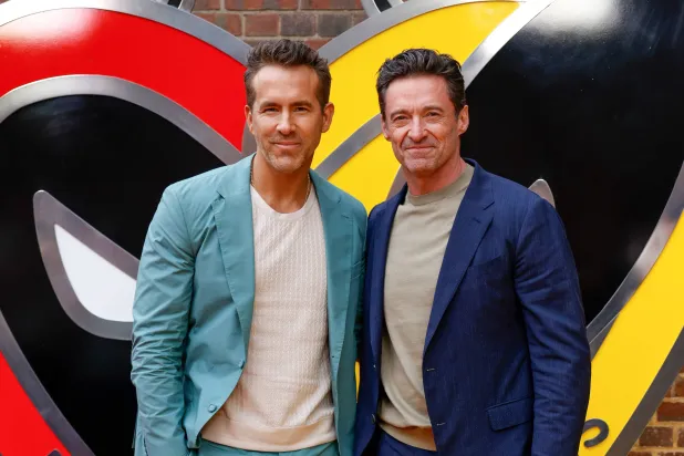 Ryan Reynolds, left, and Hugh Jackman pose for photographers upon arrival at the screening of the film "Deadpool & Wolverine" on July 11, 2024 in London. (AP)