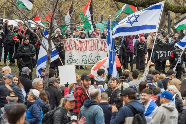 Police stand between counter-protesters and a protest encampment in support of Palestinians, during the conflict between Israel and the Palestinian group Hamas, at McGill University’s campus in Montreal, Quebec, Canada May 2, 2024. (Reuters) 