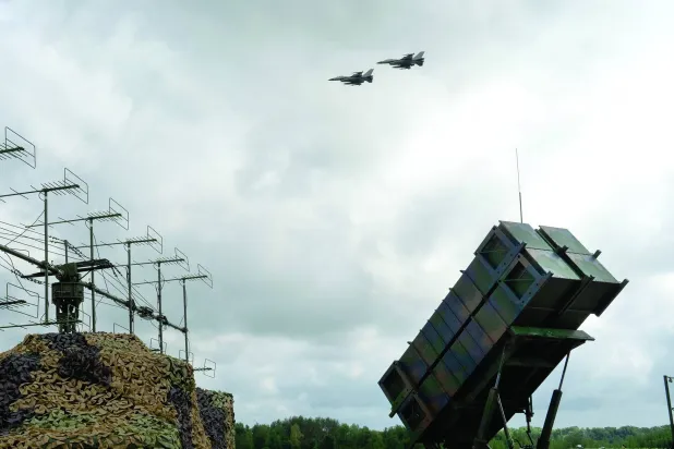 FILE - Ukrainian Air Force's F-16 fighter jets fly over a Patriot Air and Missile Defense System in an undisclosed location in Ukraine, on Aug. 4, 2024.  (AP Photo/Efrem Lukatsky, File)