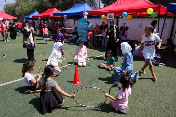 Displaced children play during an activity organized by the NGO Save the Children at a school turned into a shelter for displaced families in Tyre, southern Lebanon, August 27, 2026. (Reuters)