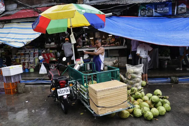 A vendor loads coconuts into a cart to transport them by tricycle in Quezon City, Metro Manila, Philippines, 04 September 2026. EPA/ROLEX DELA PENA