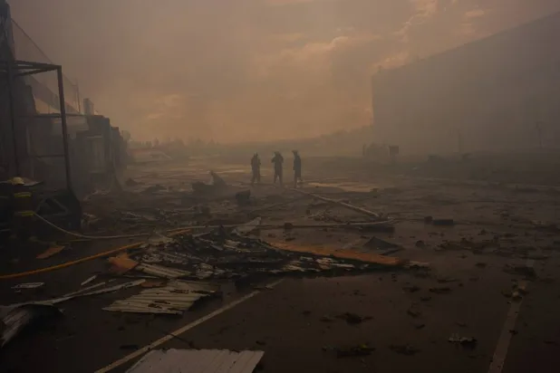 Firefighters walk among debris at a destroyed pharmaceutical warehouse after Russian drone attacks on the outskirts of Kyiv, Ukraine, Thursday, Sept. 3, 2026. (AP)