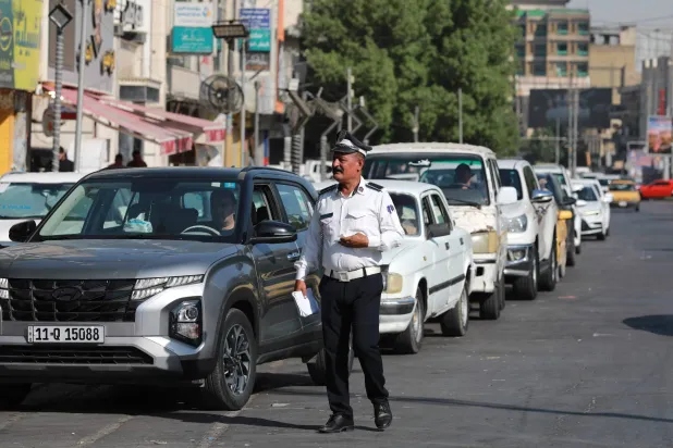 An Iraq's traffic police officer controls the queues at a petrol station in the Iraqi capital Baghdad on September 5, 2026. (AFP)