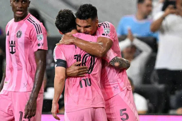 Inter Miami's Argentine forward Lionel Messi, center, is hugged by teammate Casemiro, right, scored a goal off a Messi corner kick in a 2-2 MLS draw with Atlanta. CHANDAN KHANNA / AFP
