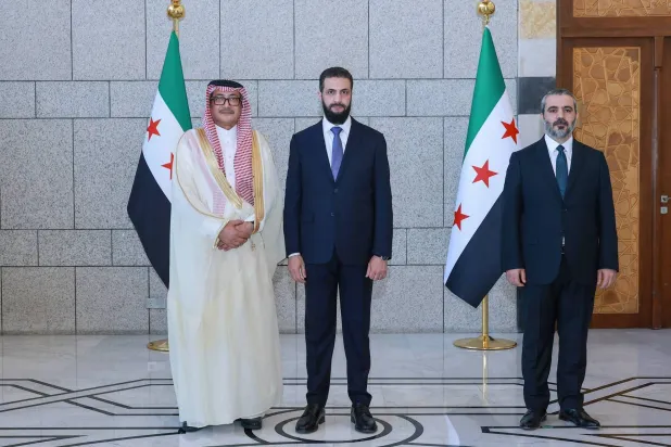 سفير المملكة العربية السعودية غازي العنزي (يساراً) بعد تقديم أوراق اعتماده للرئيس السوري أحمد الشرع بحضور وزير الخارجية أسعد الشيباني (حساب الرئاسة)
