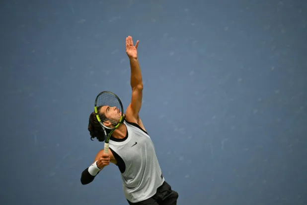 Spain's Carlos Alcaraz serves to USA's Tommy Paul during their men's singles round of 16 tennis match on day eight of the US Open tennis tournament at the USTA Billie Jean King National Tennis Center in New York on September 6, 2026. (AFP)