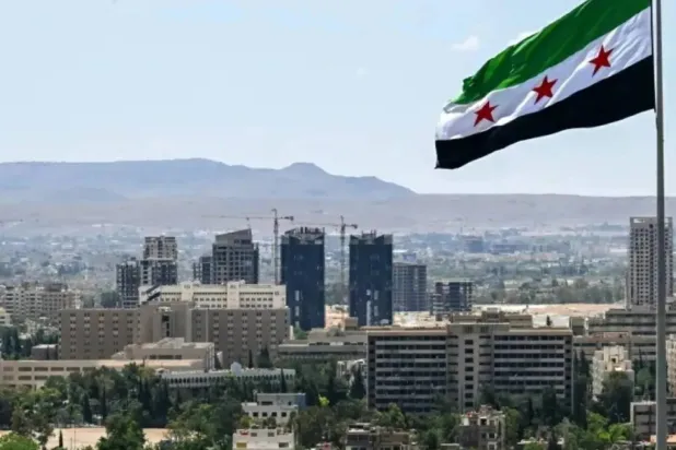 A large Syrian flag flutters above Tishreen Park in Damascus, June 4, 2025. (AFP)
