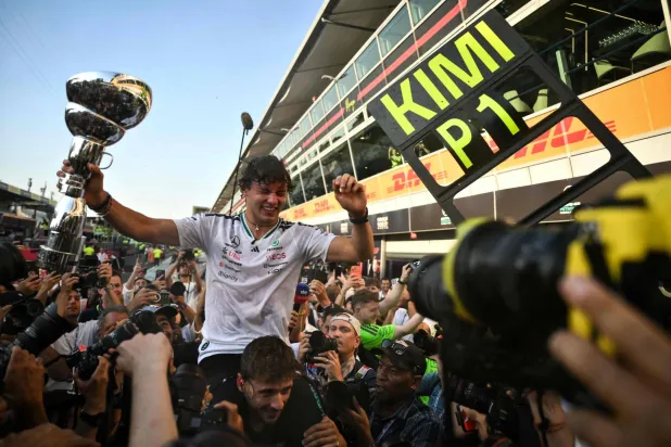 Mercedes' Italian driver Kimi Antonelli holds his trophy as he celebrates with his team members after winning the Italian Formula One Grand Prix at the Autodromo Nazionale Monza circuit in Monza, northern Italy on September 6, 2026. (AFP)