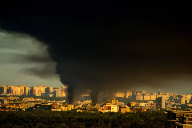 This photograph shows smoke rising following Russian missiles strike in Kyiv, Ukraine, early on September 8, 2026. (Photo by Eugene KOTENKO / AFP)