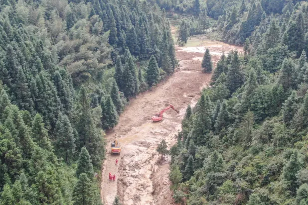 A drone view shows construction machinery clearing a road to the mudslide-hit Mingkeng village after heavy rainfall associated with Typhoon Saudel, in Suichuan county, Jian, Jiangxi province, China September 6, 2026. (cnsphoto via Reuters)