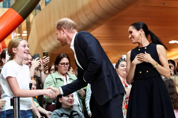 FILE PHOTO: Prince Harry, the Duke of Sussex, greets a girl as he visits the Royal Children's Hospital along with Meghan, Duchess of Sussex, in Melbourne, Australia, April 14, 2026. REUTERS/Mark Peterson/File Photo