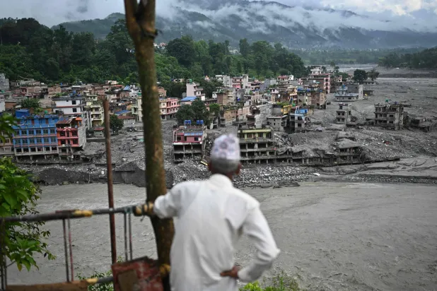 A man looks at the remains in the aftermath of flash floods at Trishuli in Nepal's Nuwakot district on September 7, 2026. (AFP)