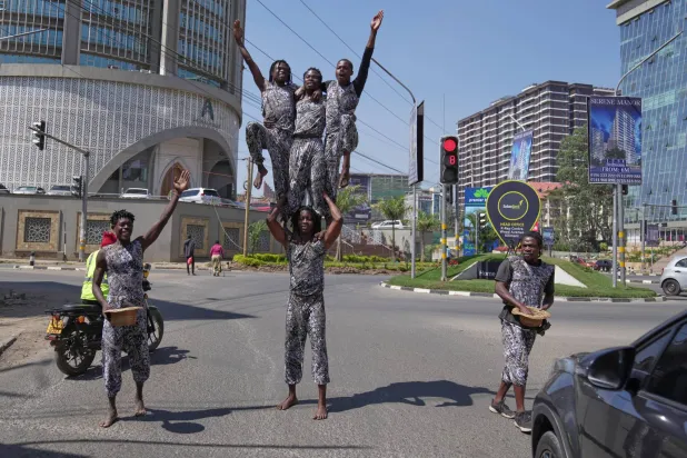 Acrobats perform in a busy street amid by traffic in Nairobi, Kenya, Wednesday, Aug. 26, 2026. (AP)