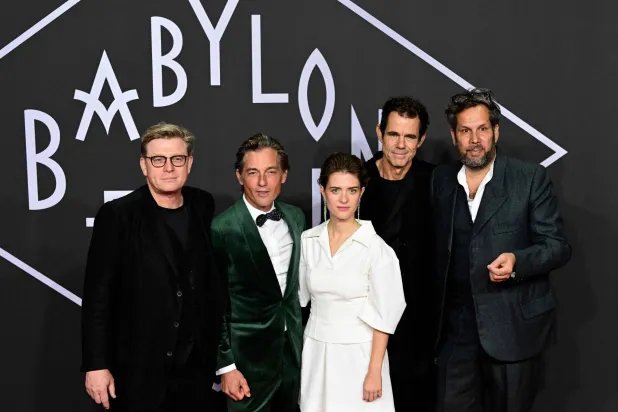 German directors and screenwriters Henk Handloegten (L), Tom Tykwer (2ndR) and Achim von Borries (R) and German actor Volker Bruch (2ndL) and German actress Liv Lisa Fries pose on the red carpet upon arrival for the premiere of the "Babylon Berlin" TV series' fourth season, at the Delphi Filmpalast in Berlin on September 20, 2022. (AFP)
