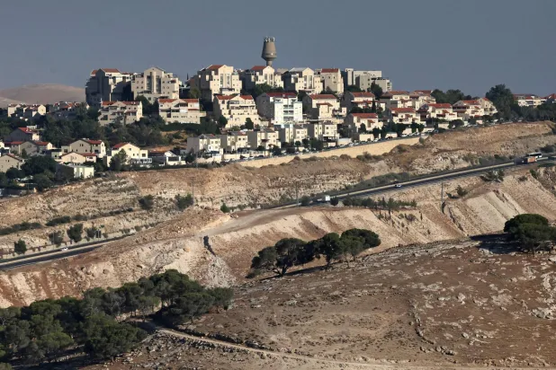 This photograph taken from the E1 corridor, an area in the occupied West Bank shows vehicles driving along the highway near the Israeli settlement of Maale Adumim, on September 8, 2026. (AFP)