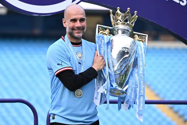(FILES) Manchester City's Spanish manager Pep Guardiola poses with the Premier League trophy after the presentation ceremony following the English Premier League football match between Manchester City and Chelsea at the Etihad Stadium in Manchester, north west England, on May 21, 2023. (Photo by Oli SCARFF / AFP)