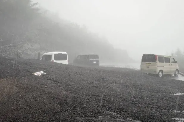 Vehicles buried by mud and debris after a landslide swept into the parking lot at Fifth Station of Mount Fuji's Fujinomiya Trail. Shizuoka Prefecture/AFP
