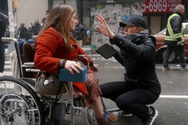This image released by Apple shows Ruth Madeley, left, with director Sian Heder during the filming of "Being Heumann." (Apple TV via AP) 