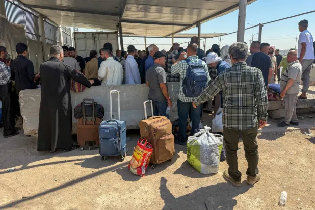 Travelers at the Shalamsheh border crossing between Iraq and Iran after Iraqi authorities ordered its closure as a precautionary measure following the latest drone attacks on Saudi Arabia on September 12, 2026 (Reuters)